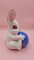Vintage ceramic bunny rabbit holding a blue egg. 6
