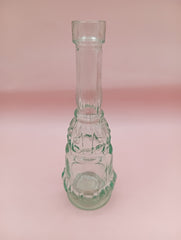 Vintage miniature apothecary-style green glass bottle with figural design
