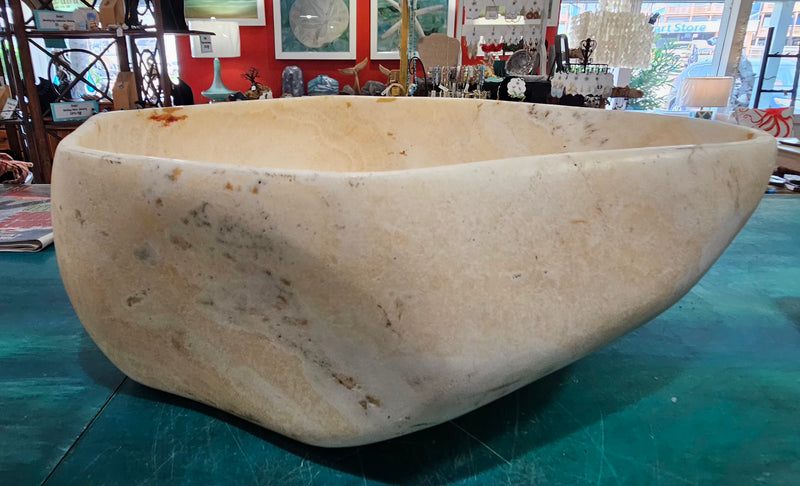 Oversized hand-carved onyx bowl in cream tones with natural marbling, measuring 20 inches wide.