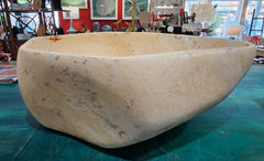 Oversized hand-carved onyx bowl in cream tones with natural marbling, measuring 20 inches wide.