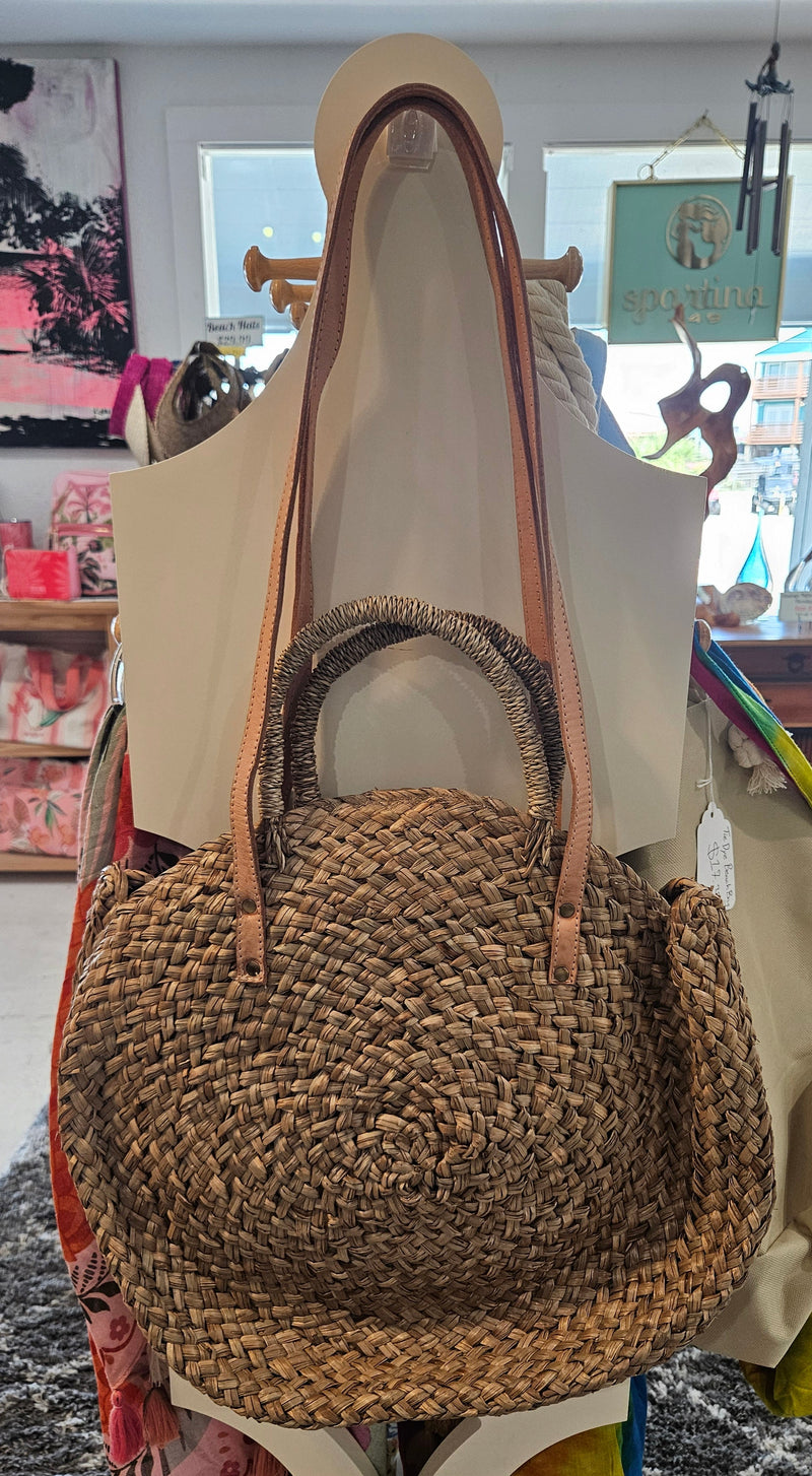 round woven straw tote bags in beige, black, and brown 