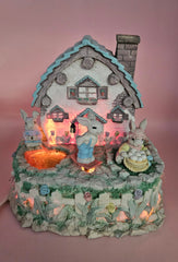 Vintage ABC Easter bunny cottage figurine with lighted house, animated bunnies, and music box that plays 