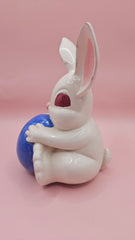 Vintage ceramic bunny rabbit holding a blue egg. 6