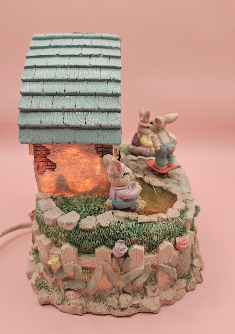 Vintage ABC Easter bunny cottage figurine with lighted house, animated bunnies, and music box that plays "Easter Parade" – ceramic 6-inch display