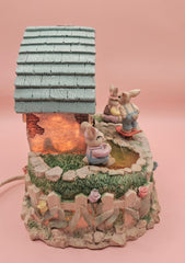 Vintage ABC Easter bunny cottage figurine with lighted house, animated bunnies, and music box that plays 