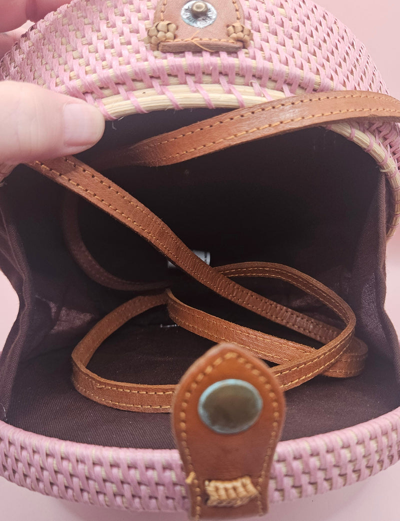 Round rattan crossbody bags in 4 styles—natural, pink, whitewash, and floral weave—with fabric-lined interior