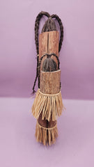 Vintage African mother and child doll, handcrafted with wood and raffia skirts, depicting cultural significance.