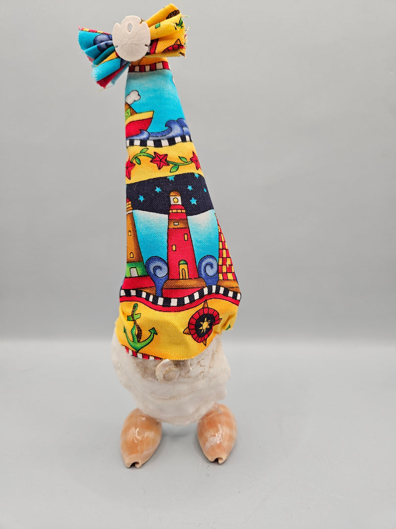 handcrafted seashell gnome with a colorful fabric hat and real seashells, perfect for coastal or beach-themed decor.