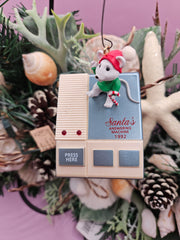 Vintage 1992 Hallmark Keepsake Ornament featuring Santa's Answering Machine, with untested sound functionality, displayed on a festive tree with holiday lights.