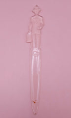 Vintage clear plastic Fuller Brush Man letter opener, shaped like a businessman holding a briefcase, measuring 7.25 inches long.