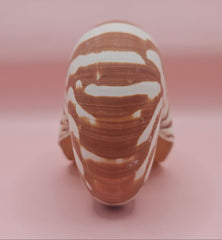4-inch natural nautilus shell with smooth spiral pattern and creamy pearlescent finish.