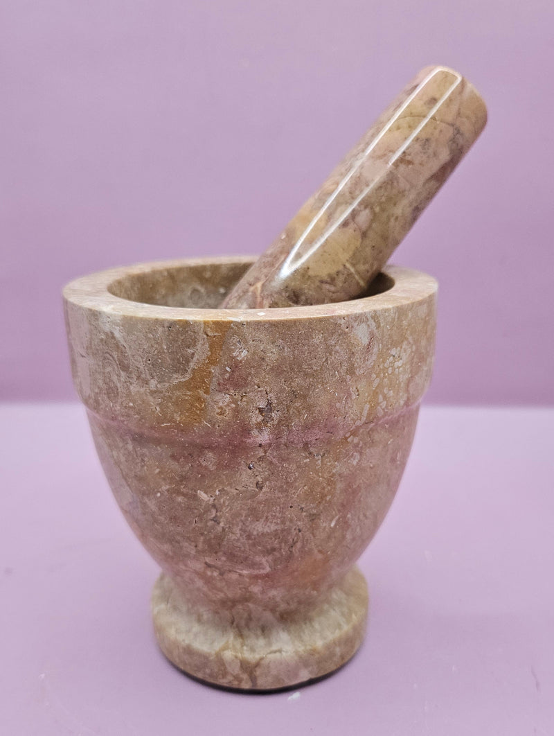 Three stone mortar and pestle sets in beige, brown, and black, featuring a durable design for grinding spices and herbs.