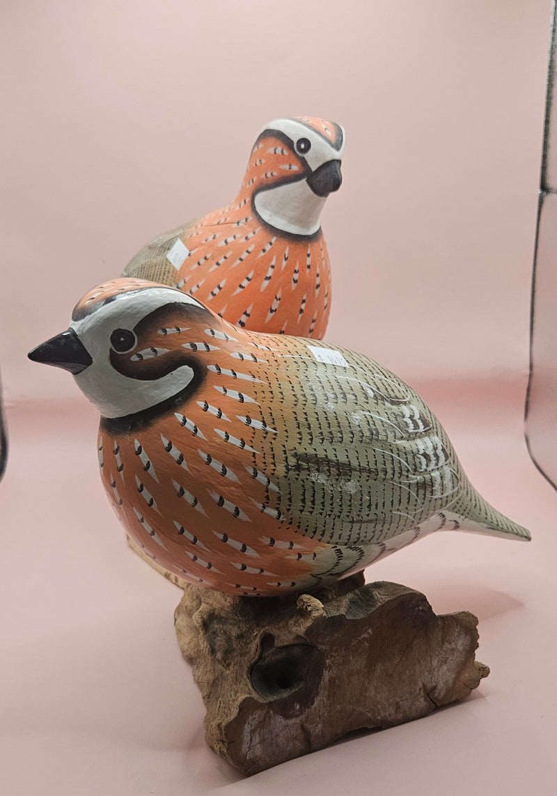 Handmade orange quail bird figurines in sitting and standing poses, mounted on rustic wooden bases
