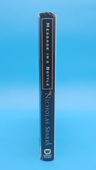 1998 hardcover edition of Message in a Bottle by Nicholas Sparks with dust jacket showing sailboat on ocean waves.