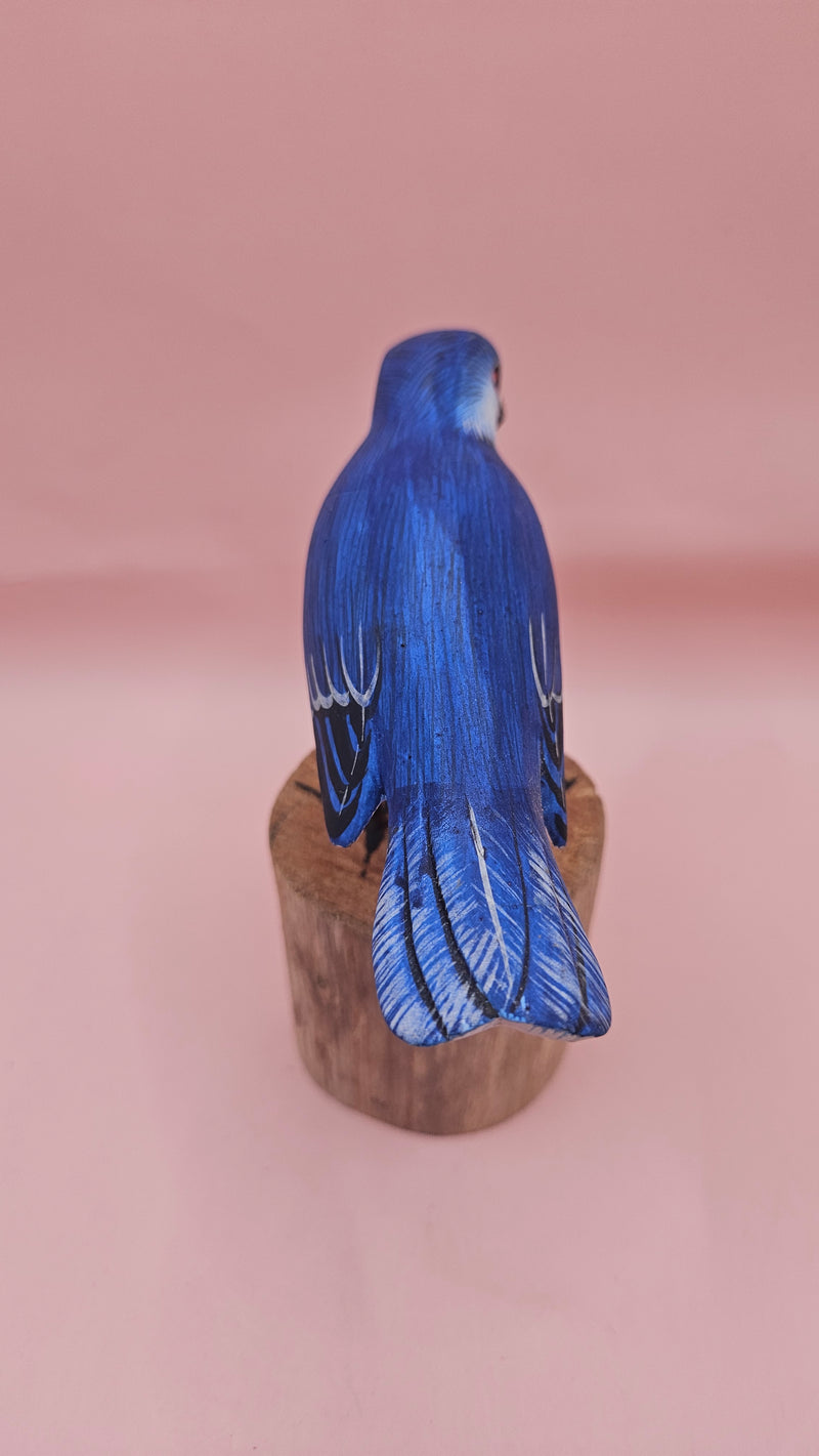 Hand-painted blue songbird figurine on a wood stump, approx. 5.5x2.5 inches