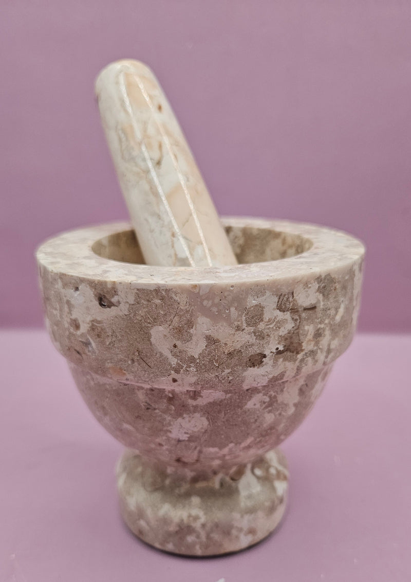 Three stone mortar and pestle sets in beige, brown, and black, featuring a durable design for grinding spices and herbs.