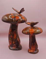 Vintage ceramic mushroom decor set with butterfly accents, hand-painted in brown and orange, two-piece set on pink background