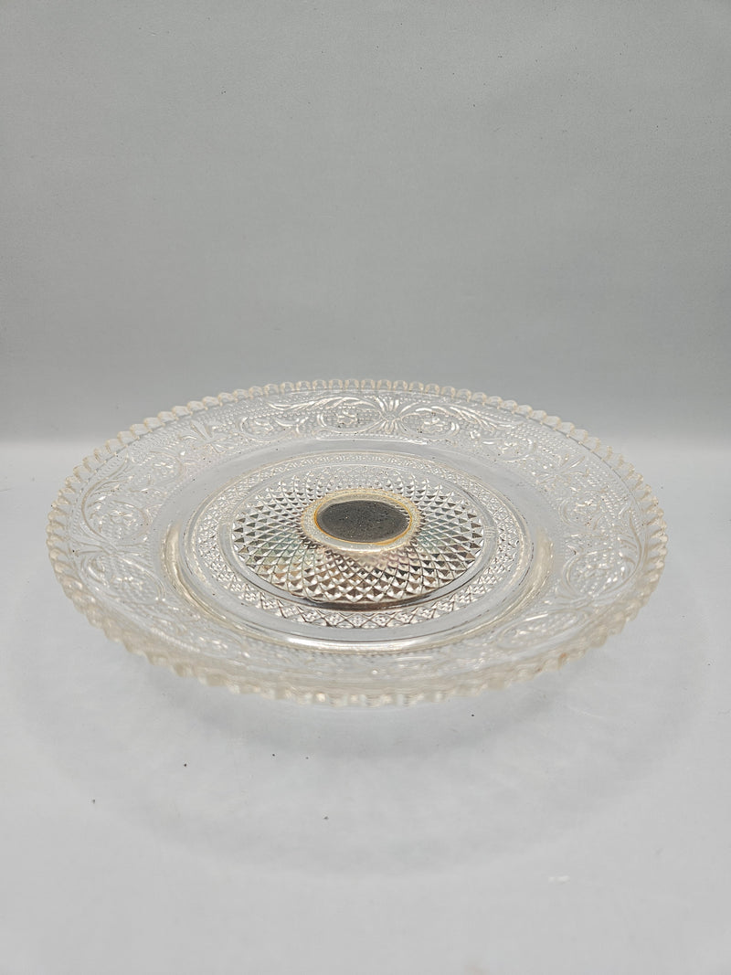 A close-up view of a silver-plated crystal pedestal server, featuring a luxurious combination of silver and crystal. The server measures 5.75"W x 1.5"H and is presented in its original packaging, perfect for serving or as a decorative item