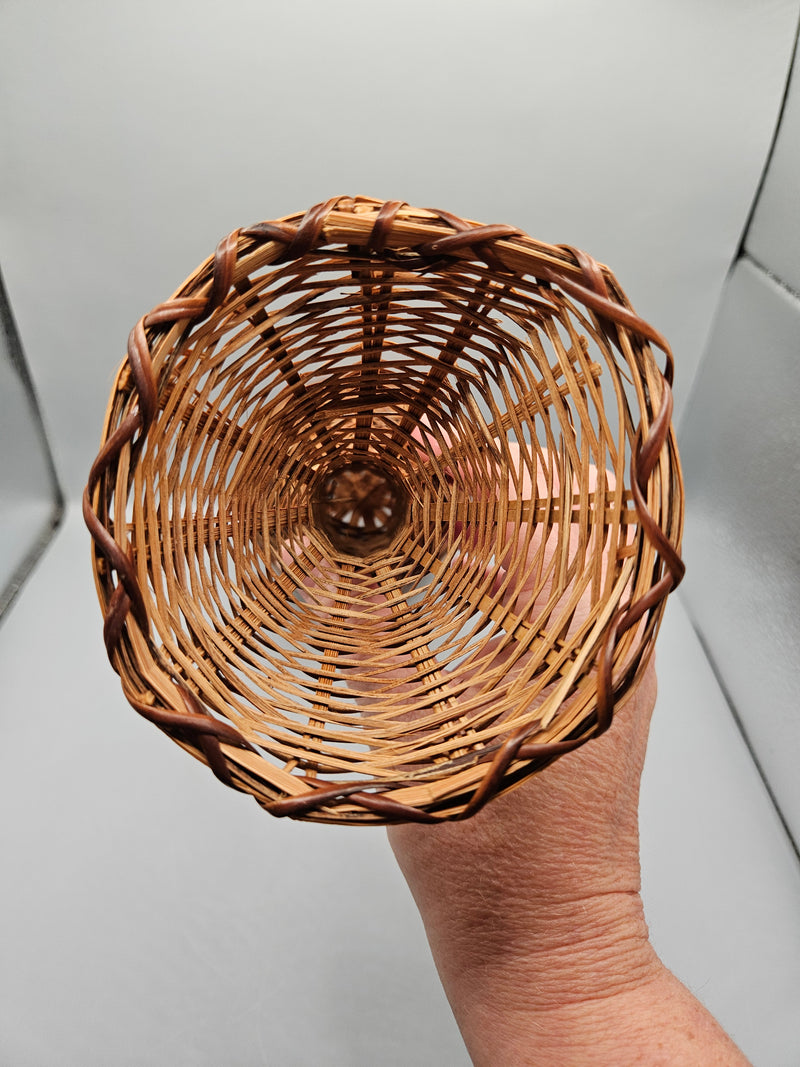 A 12.5" vintage woven wicker rattan vase basket with an hourglass shape, handcrafted from natural rattan, perfect for rustic or boho decor.