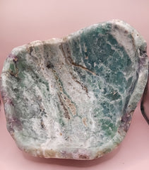 and-carved fluorite bowl featuring layers of green, purple, and aqua crystal