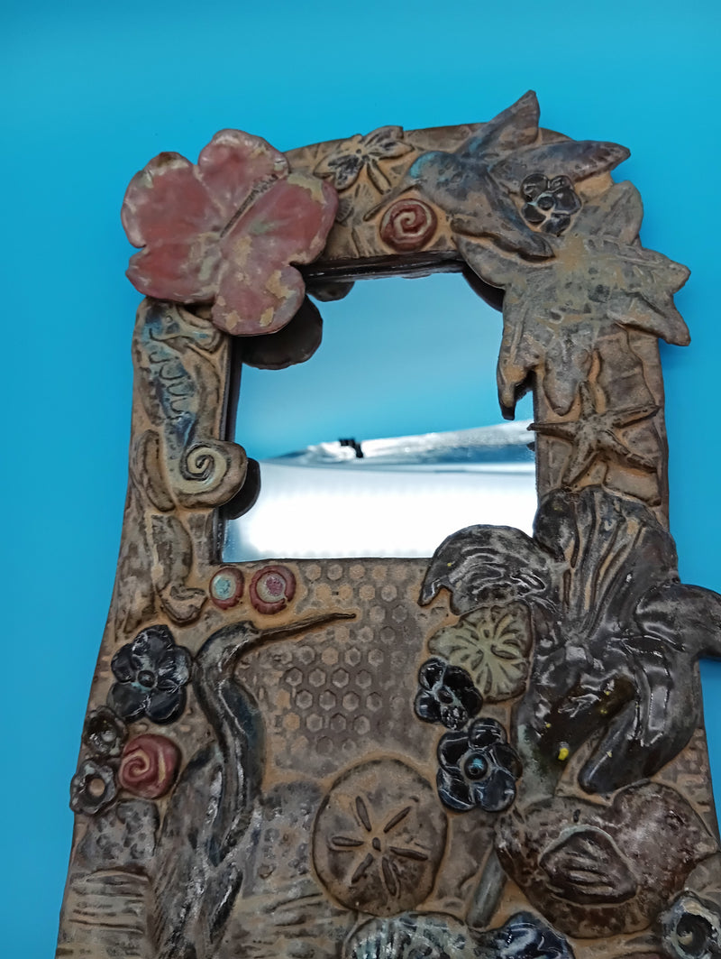 Handmade ceramic coastal mirror with hibiscus, heron, shells, and sand dollar – 13.5" x 8"