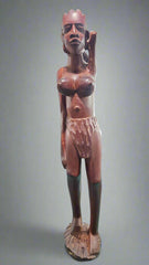 Vintage African tribal sculpture, solid wood, showcasing a tall figure with traditional attire and intricate carving.