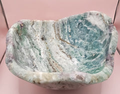 and-carved fluorite bowl featuring layers of green, purple, and aqua crystal