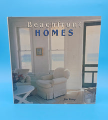Cover of Beachfront Homes by Jim Kemp featuring bright coastal living room with ocean view through open windows.