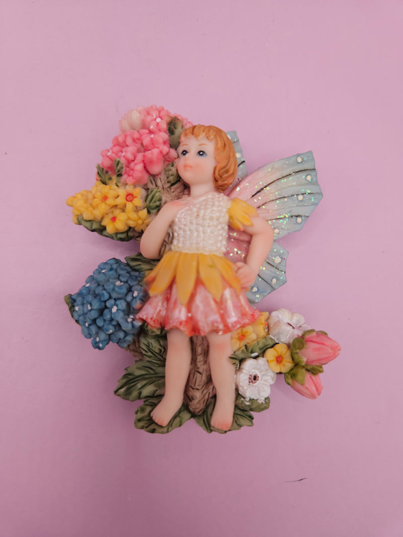 Fairy garden magnets with pastel wings and floral designs, each measuring approximately 3 inches.