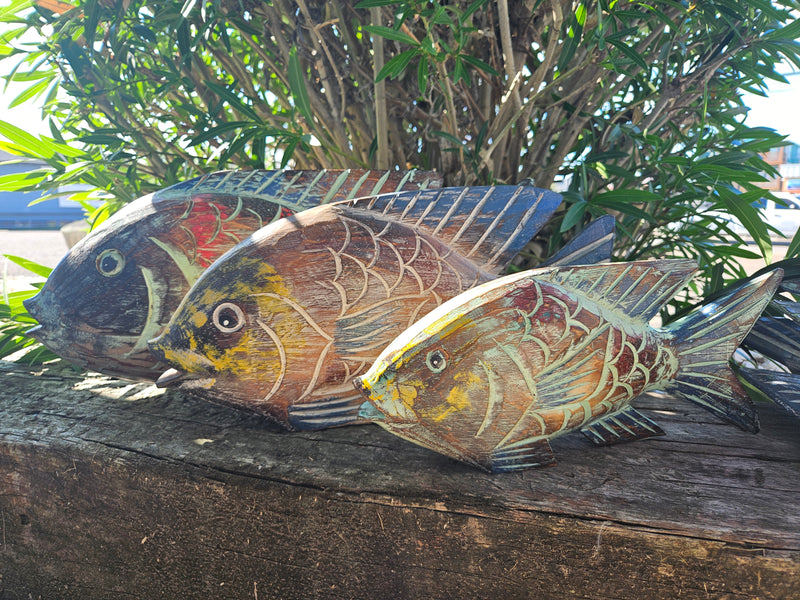 Carved wooden fish nautical home decor in blue and green, available in three sizes: small, medium, and large, perfect for coastal-themed decor