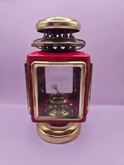 Vintage red and gold nautical oil lamp lantern with glass panels and vent, 7.5 inches by 4 inches, perfect for coastal decor