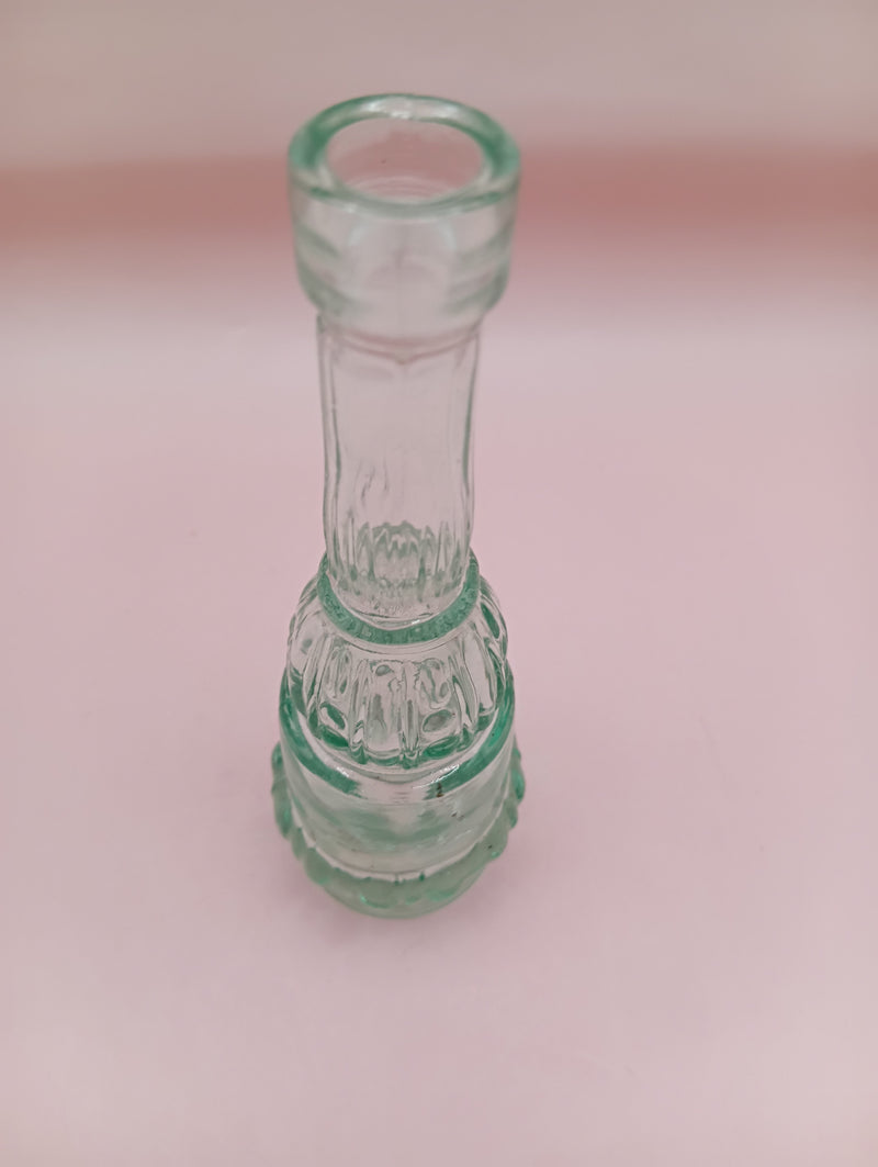 Vintage miniature apothecary-style green glass bottle with figural design