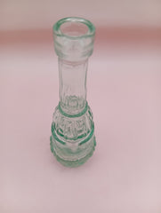 Vintage miniature apothecary-style green glass bottle with figural design