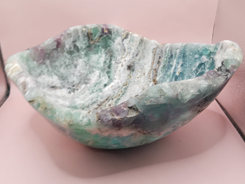 and-carved fluorite bowl featuring layers of green, purple, and aqua crystal