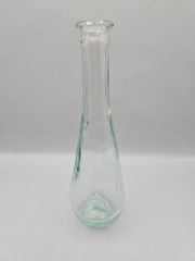 Vintage teardrop-shaped glass bottle, 7 inches tall by 2 inches wide, clear glass, perfect for décor or as a small vase.