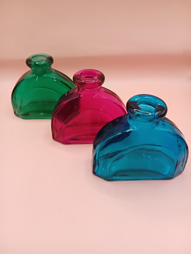 Miniature vintage glass apothecary bottle in round shape – available in green, pink, and teal