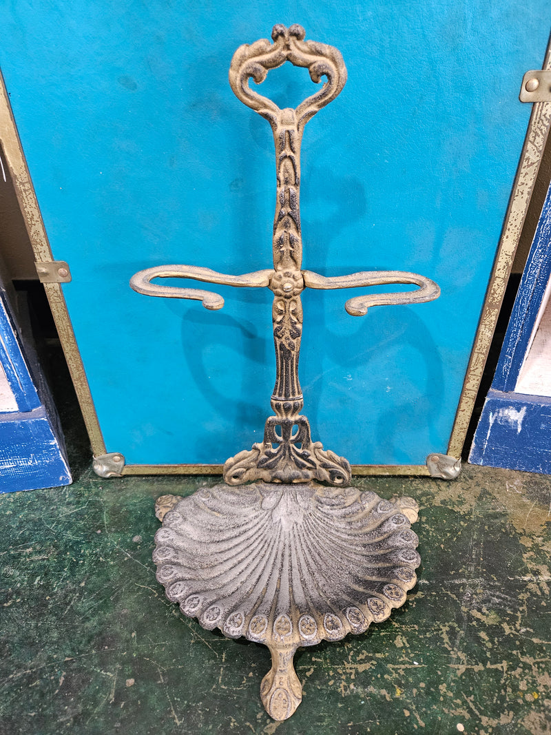 An antique royal cast metal stand, 16.75"x9.5", with intricate detailing and a vintage, ornate design, ideal for displaying decorative items or as a centerpiece.