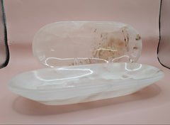 Polished onyx dish with natural cream veining on pink background