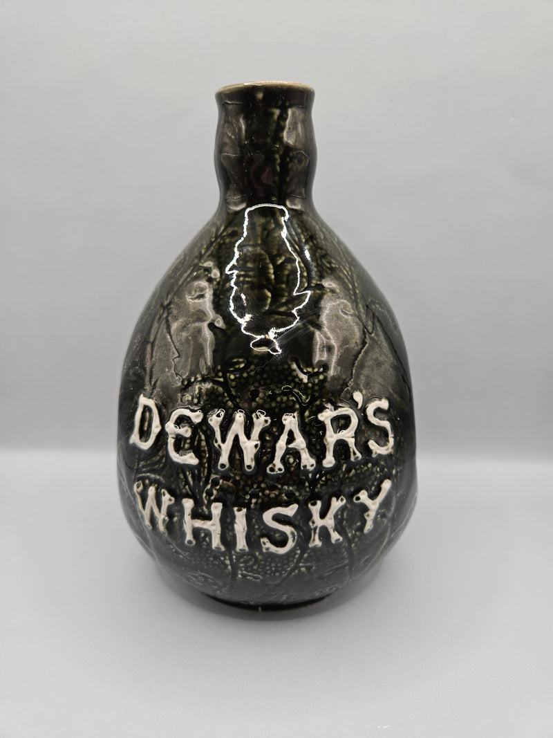  vintage Dewar's Whiskey ceramic decanter, measuring 7.5"x5.5", without a stopper. Perfect for display or bar decor.