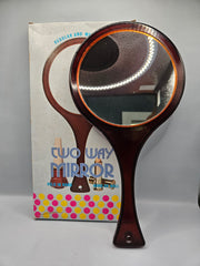 Vintage two-way mirror, 12 inches by 6 inches, can be held in hand or hung on the wall, still in original packaging