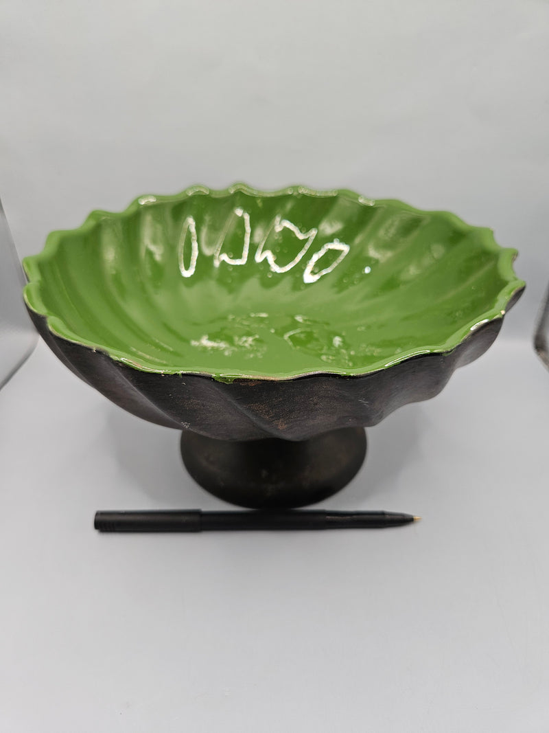 green ceramic scalloped footed bowl measuring 4.75"x8.5", perfect as a decorative centerpiece or functional bowl in any room.