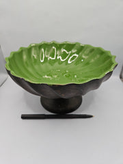 green ceramic scalloped footed bowl measuring 4.75