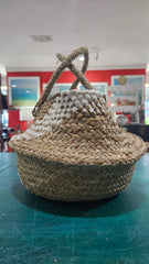 Handwoven seagrass belly basket with white diamond pattern and handles, 11.5x9.5 size on display