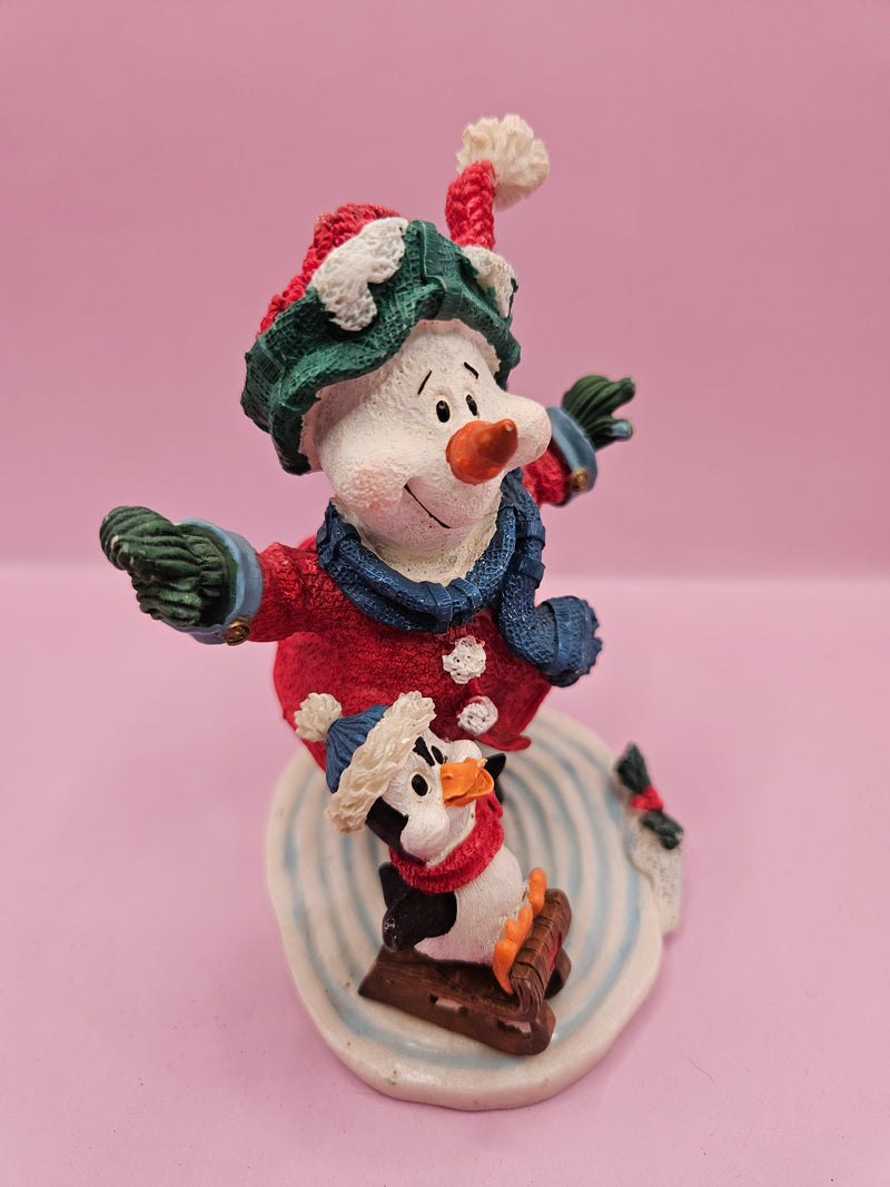 Vintage ice skating snowman and penguin figurine, 4.5 inches tall by 4 inches wide, perfect for holiday decor and winter displays