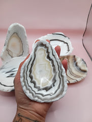 Polished natural onyx shell bowls with layered cream, gray, and brown tones