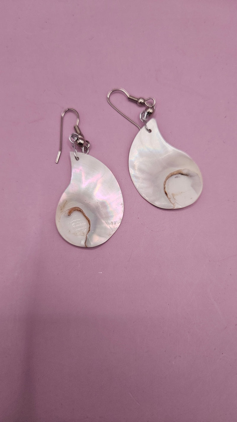 2.5" vintage nautilus shell earrings with polished iridescent shells, displayed against a pink background 