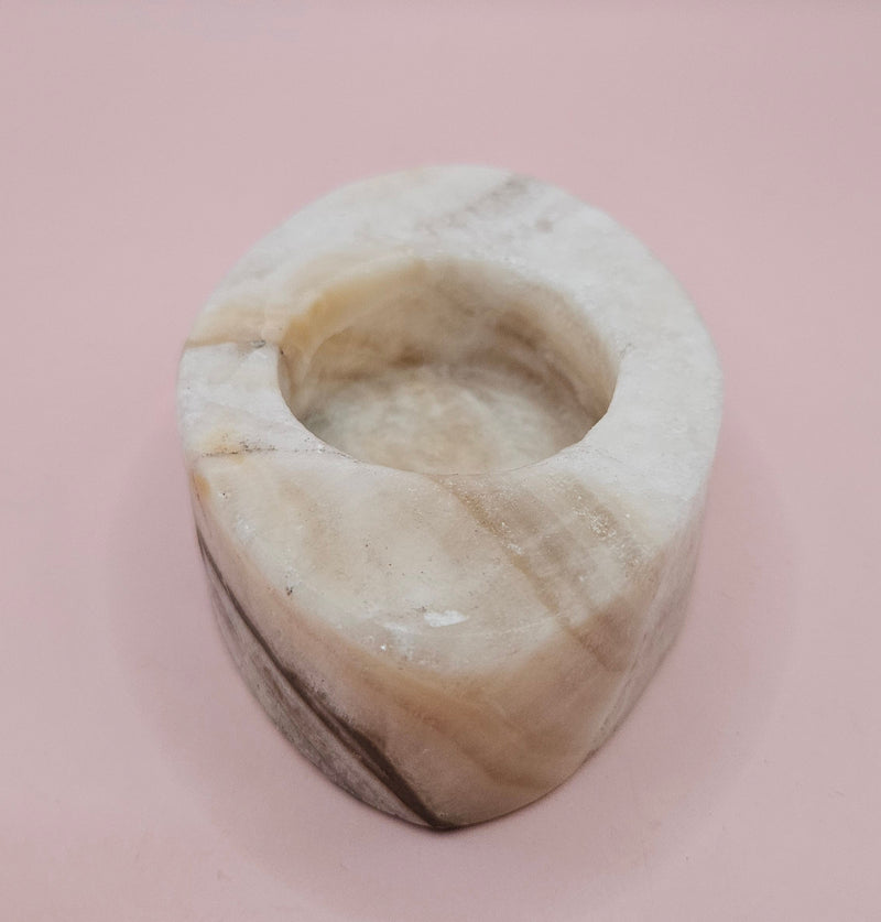 Oval-shaped onyx candle holder in white and brown natural stone, 3.7x2.6x1.2 inches