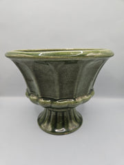 A vintage olive green ribbed pedestal planter/vase by FTD and Haeger, perfect for home decor or displaying plants, with a mid-century aesthetic.