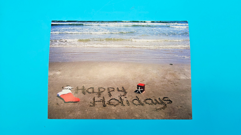 Happy Holidays beach card with sand writing