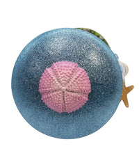 Decorative item with a blue glittery sphere and pink sea urchin on a white background